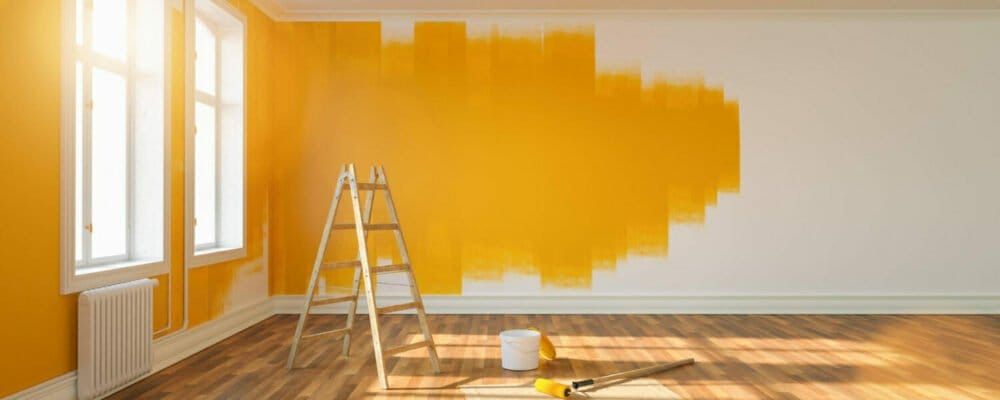painting-wall-yellow-room-apartment-after-relocation-with-ladder-paint-bucket